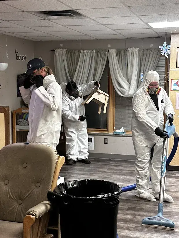 Technicians in protective gear cleaning a sewage backup in Agoura Hills, CA