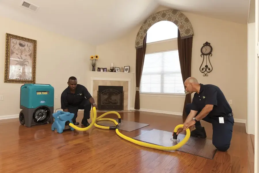 Technicians extracting standing water from a hardwood floor in Agoura Hills, CA